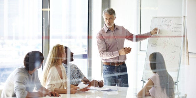 A group of businesspeople listening to their team leader