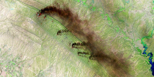 BAGHDAD, IRAQ NOVEMBER 12: (SOUTH AFRICA OUT) A Shortwave Infrared (SWIR) satellite view of the Baiji North Oil Refinery on November 12, 2015 in Baghdad, Iraq. Fires and dark plumes of smoke seen pouring from the Hamrin Mountains near the Baiji North Oil Refinery and oil fields in Iraq. Various heat sources are visible throughout the mountain range. (Photo by USGS/NASA Landsat/Orbital Horizon/Gallo Images/Getty Images)