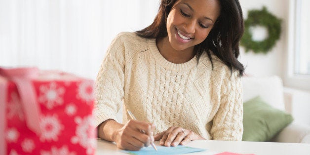 African American woman writing at desk