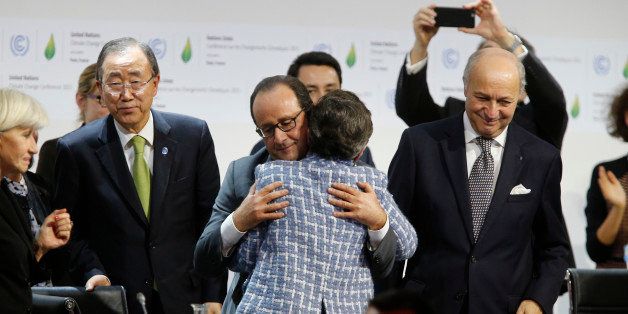 Executive Secretary of the United Nations Framework Convention on Climate Change (UNFCCC) Christiana Figueres (C-R) and France's President Francois Hollande (C-L) hug after the adoption of a historic global warming pact at the COP21 Climate Conference in Le Bourget, north of Paris, on December 12, 2015. Envoys from 195 nations on December 12 adopted to cheers and tears a historic accord to stop global warming, which threatens humanity with rising seas and worsening droughts, floods and storms. AFP PHOTO / FRANCOIS GUILLOT / AFP / FRANCOIS GUILLOT (Photo credit should read FRANCOIS GUILLOT/AFP/Getty Images)