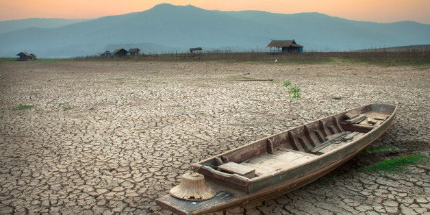 The wood boat on cracked earth, metaphoric for climate change and global warming.