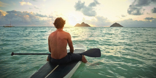 Caucasian man on paddle board in ocean