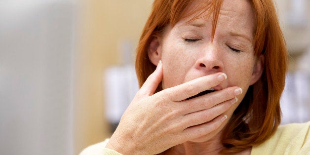 Businesswoman yawning