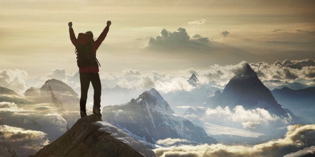 Climber standing on a mountain summit