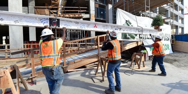 IMAGE DISTRIBUTED FOR GREENLAND USA - Construction workers begin to raise final beam at Greenlandâs Top-off of Tower I at Metropolis Tuesday, Dec. 8, 2015, in Los Angeles. (Photo by Jordan Strauss/Invision for Greenland USA/AP Images)