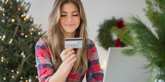 Young woman using credit card during online shopping