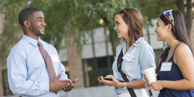 Young college student studying class schedule or campus map