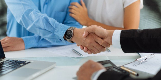 Close-up image of real estate agent and his client shaking hands
