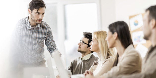 Medium group of business people on a meeting. One of them is giving a speech. 