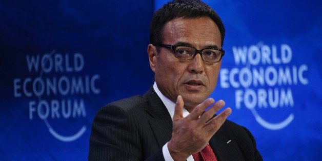 Takeshi Niinami, president of Suntory Holdings Ltd., gestures whilst speaking during a panel session at the World Economic Fo