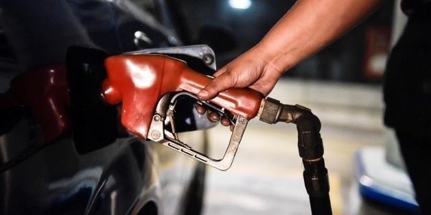 CARACAS, VENEZUELA -FEBRUARY 17: A worker puts gasoline to a vehicle in Caracas, Venezuela on February 17, 2016. Venezuela's