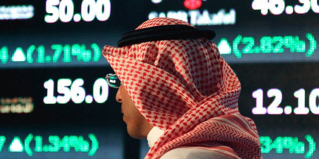 A Saudi man walks at the Tadawul Saudi Stock Exchange, in Riyadh, Saudi Arabia, Monday, June 15, 2015. Saudi Arabia's stock m