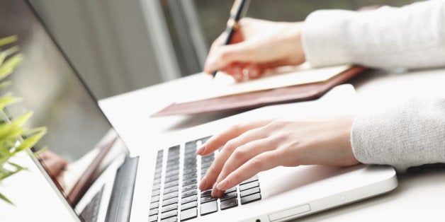 Close-up of businesswoman's hands doing paperwork.