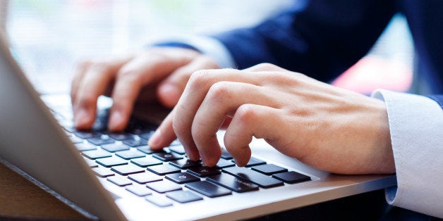 close up view of businessman typing on laptop indoors