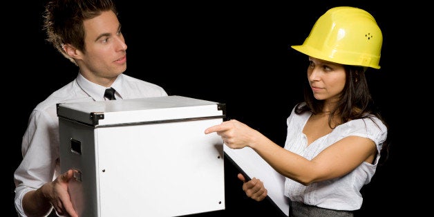 Business woman with hard helmet delegating a businessman