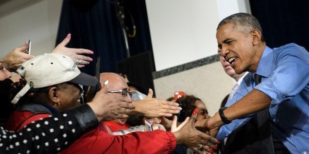 US President Barack Obama greets people while he arrives to speak at the United Auto Workers-General Motors Center for Human Resources January 20, 2016 in Detroit, Michigan. / AFP / Brendan Smialowski (Photo credit should read BRENDAN SMIALOWSKI/AFP/Getty Images)