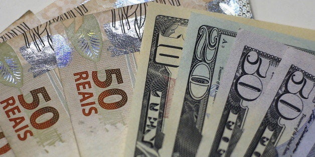 Brazilian Real and U.S. dollar notes are pictured at a currency exchange office in Rio de Janeiro, Brazil, in this September 10, 2015 photo illustration. One thing is clear for Brazil's economy after its credit rating was downgraded to junk: political leaders now have little choice but to push ahead with painful austerity measures if they hope to regain market confidence. Standard & Poor's on Wednesday stripped Brazil of its hard-won investment grade rating, moving sooner than the government and investors had expected. Although investors expected a downgrade at some point, they still sold off Brazilian assets early on Thursday. Stocks suffered modest losses while the currency, the real, fell nearly 3 percent to a 13-year low of 3.9 per dollar. REUTERS/Ricardo Moraes