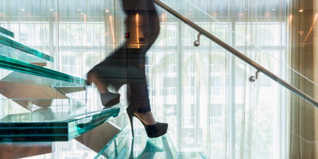 Blurred businesswoman climbing stairs in office