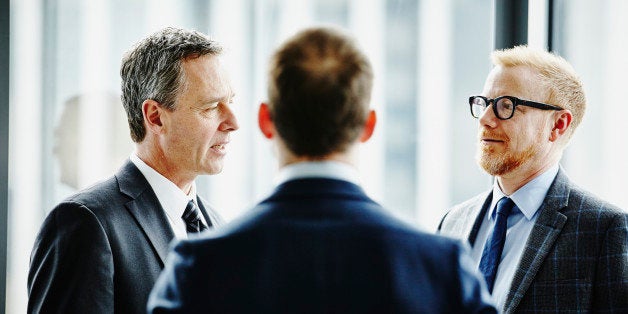 Group of business executives having informal meeting in office