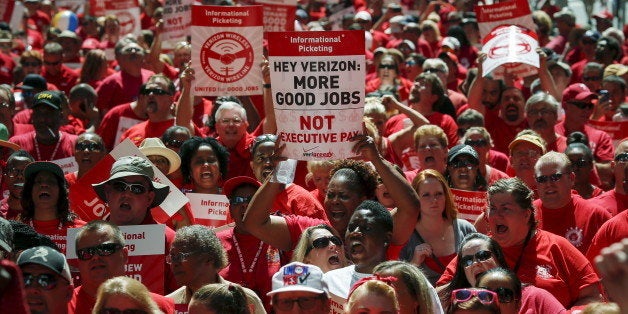 Verizon workers take part in a rally as they negotiate a union contract in New York July 25, 2015. REUTERS/Eduardo Munoz