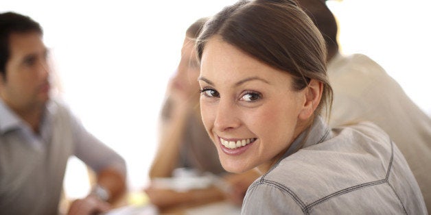 Portrait of smiling working girl in meeting