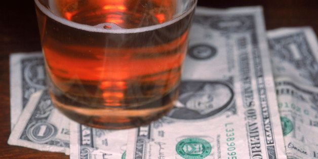 Pint of beer and dollar bills