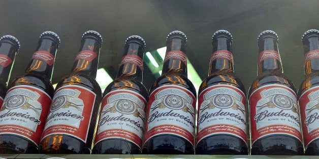 FILE - This is a Tuesday, Oct. 13, 2015 file photo of bottles of Budweiser beer in a shop window in London. Budweiser maker Anheuser-Busch InBev on Wednesday Nov. 11, 2015 announced a final agreement to buy SABMiller for 71 billion pounds ($107 billion), in a deal that will combine the world's two biggest brewers and create a company that makes almost a third of the beer consumed worldwide. (AP Photo/Kirsty Wigglesworth, File)