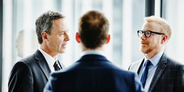 Group of business executives having informal meeting in office