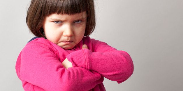 unhappy boyish 4-year old girl expressing disagreement with body language