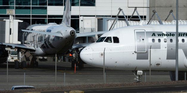 DENVER, CO - JANUARY 16: A Frontier airplane taxis past other planes at the A-concourse at Denver International Airport January 16, 2015. Frontier Airlines announced Friday that it is outsourcing over 1300 reservations and airport operations jobs in Denver and Milwaukee. (Photo by Andy Cross/The Denver Post via Getty Images)