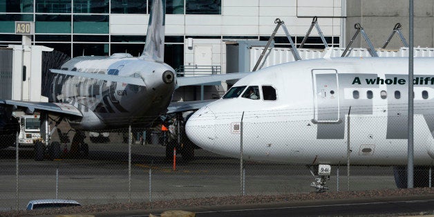 DENVER, CO - JANUARY 16: A Frontier airplane taxis past other planes at the A-concourse at Denver International Airport Janua