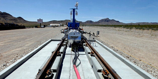 A recovery vehicle and a test sled sit on rails after the first test of the propulsion system at the Hyperloop One Test and Safety site on May 11, 2016 in Las Vegas, Nevada.Hyperloop One stages the first public demonstration of a key component of the startup's futuristic rail transit concept that could one day ferry passengers at near supersonic speeds. / AFP / John GURZINSKI (Photo credit should read JOHN GURZINSKI/AFP/Getty Images)