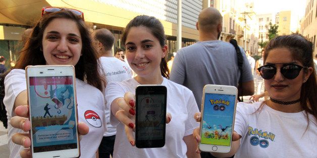 Gamers use the Pokemon Go application on their mobiles in Beirut on July 17, 2016. / AFP / ANWAR AMRO (Photo credit should read ANWAR AMRO/AFP/Getty Images)