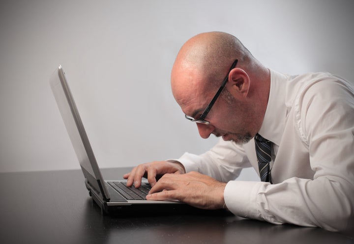 bored businessman using a laptop