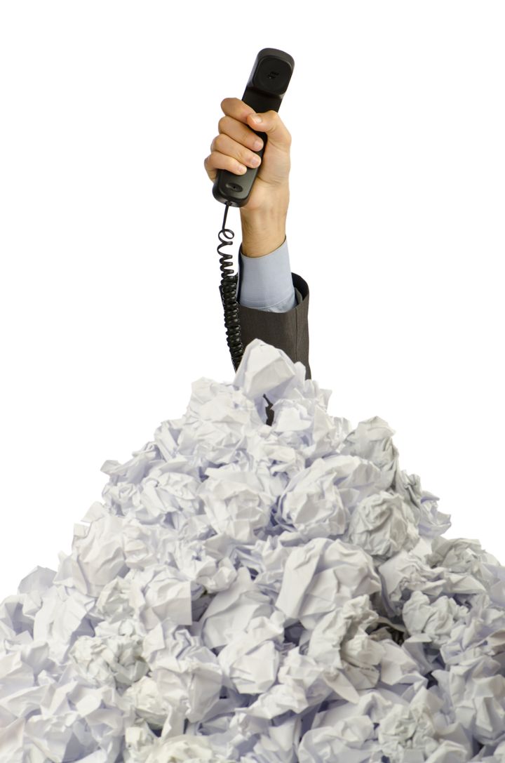 man with lots of crumpled paper