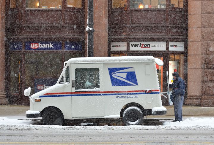 CHICAGO, IL - MARCH 5: A mail carrier loads his truck on March 5, 2013 in Chicago, Illinois. The worst winter storm of the season is expected to dump 7-10 inches of snow on the Chicago area with the worst expected for the evening commute. (Photo by Brian Kersey/Getty Images)