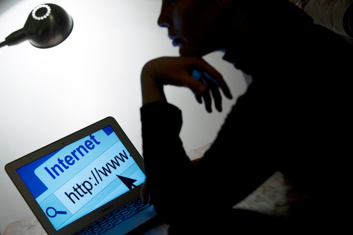 A woman looks at a webpage while connecting on the internet on March 15, 2013 in Paris. AFP PHOTO / LIONEL BONAVENTURE (Photo credit should read LIONEL BONAVENTURE/AFP/Getty Images)