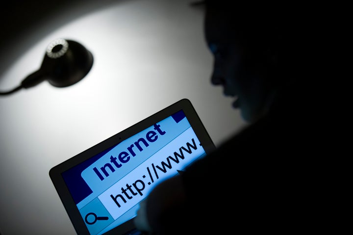 A woman looks at a webpage while connecting on the internet on March 15, 2013 in Paris. AFP PHOTO / LIONEL BONAVENTURE (Photo credit should read LIONEL BONAVENTURE/AFP/Getty Images)