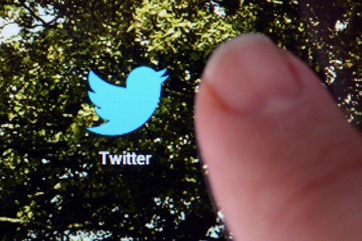 A picture taken on October 23, 2012 in Rennes, western France, shows a finger touching the screen of a handheld device that features a logo of the micro-blogging site Twitter. AFP PHOTO DAMIEN MEYER (Photo credit should read DAMIEN MEYER/AFP/Getty Images)