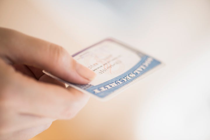 USA, New Jersey, Jersey City, Close up of woman's hand holding social security card