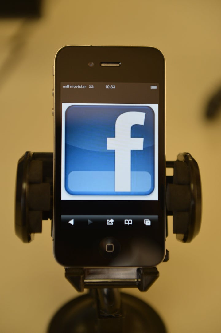 A mobile phone showing a Facebook page, in Quito, on May 10, 2012. AFP PHOTO/RODRIGO BUENDIA (Photo credit should rea