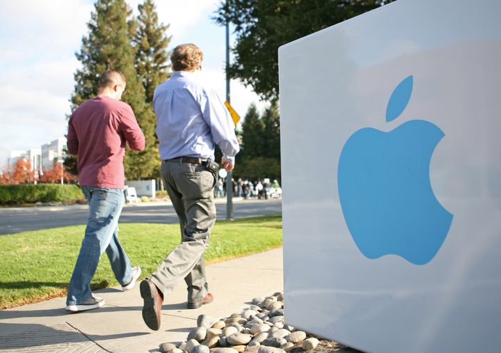 Apple employees walk towards the Apple Headquarters to attend Apple co-founder Steve Jobs' memorial service in Cupertino, California, on October 19, 2011. Apple stores across the country shut their doors for a few hours on Wednesday to allow its employees to participate in a staff celebration of the life of Jobs. AFP Photo/Kimihiro Hoshino (Photo credit should read KIMIHIRO HOSHINO/AFP/Getty Images)