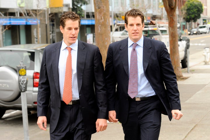Cameron Winklevoss, left, and his twin brother Tyler leave a federal appeals court in San Francisco, California, U.S., on Tue