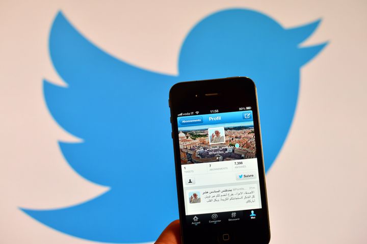 A smartphone showing the first twitter message of Pope Benedict XVI in Arabic is held in front of a computer showing the logo of Twitter on December 12, 2012 in Rome. Pope Benedict XVI sent his first Twitter message from a digital tablet on Wednesday during his weekly general audience using the handle @pontifex, blessing his hundreds of thousands of new Internet followers. AFP PHOTO / GABRIEL BOUYS (Photo credit should read GABRIEL BOUYS/AFP/Getty Images)