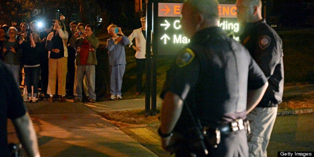 WATERTOWN, MA - APRIL 19: Curious onlookers gathered outside of Mt. Auburn Hospital, where it was originally thought the Boston Marathon bombing suspect was going to be brought after he was captured in Watertown. After an intense manhunt and two-hour standoff in Watertown, law enforcement took a person into custody believed to be related to the Boston Marathon bombings. (Photo by Essdras M Suarez/The Boston Globe via Getty Images)