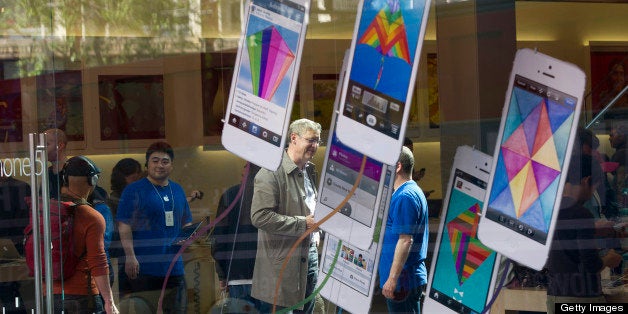 Customers talk with employees inside an Apple Inc. store in San Francisco, California, U.S., on Friday, April 19, 2013. Apple Inc. is expected to release earnings data on April 23. Photographer: David Paul Morris/Bloomberg via Getty Images