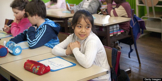 PARIS, FRANCE - FEBRUARY: Children sit in a classroom of a school in the Mairie de Paris Primary School during February 2012 in Paris,France. Photographer Richard Melloul reenacted photographs taken by Robert Doniseau at the Mairie De Paris Primary Schools in the 5th and 20th district of Paris during the 1950's. (Photo by Richard MELLOUL/Gamma-Rapho via Getty Images)