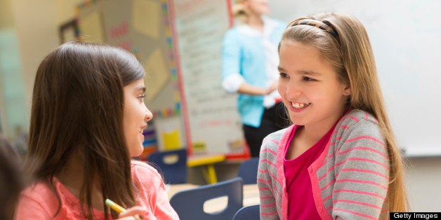 Girls working on project together in elementary school class.