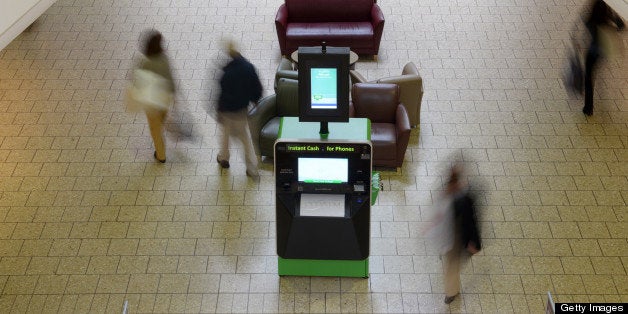 FAIRFAX, VA - MARCH 13: People walk by an ecoATM at Fair Oaks Mall on Wednesday March 13, 2013 in Fairfax, VA. (Photo by Matt McClain for The Washington Post via Getty Images)