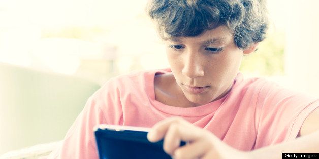 Image of a boy playing with a smartphone,